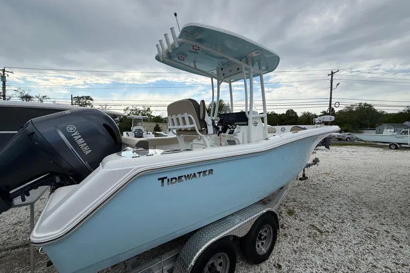 The Image of 2023 Tidewater 220 CC Adventure boat with Yamaha engine on trailer, under cloudy sky. - 1