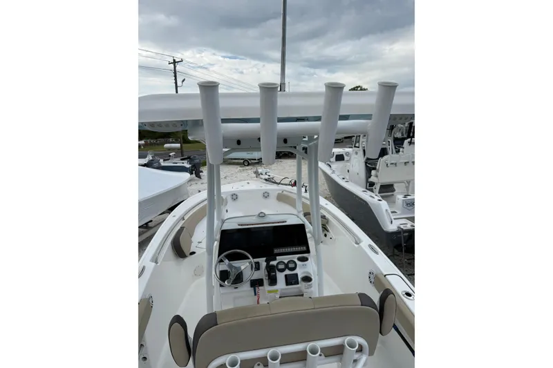Slide: The Image of 2023 Tidewater 220 CC Adventure boat interior with steering console and rod holders. - 4
