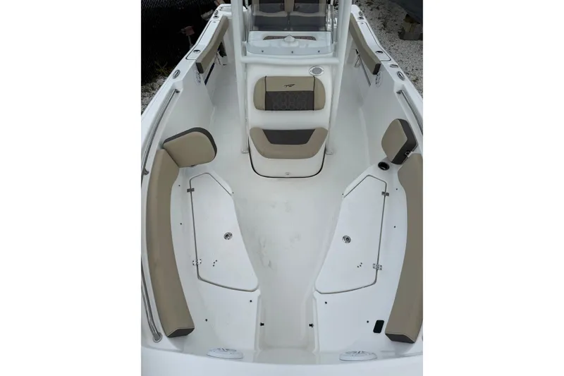 Slide: The Image of 2023 Tidewater 220 CC Adventure boat interior with cushioned seating and storage compartments. - 7