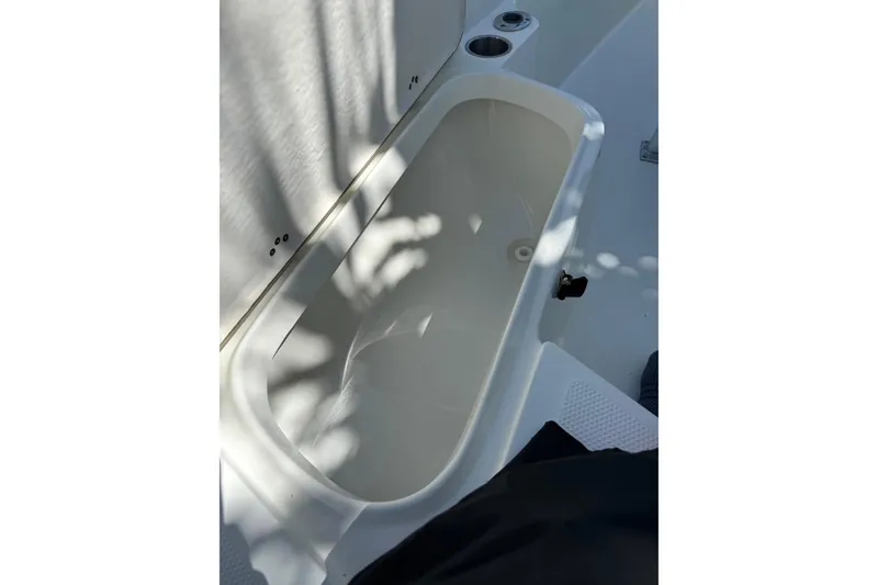 Slide: The Image of 2006 Sailfish 218 CC boat interior storage compartment with sunlight and shadows. - 10