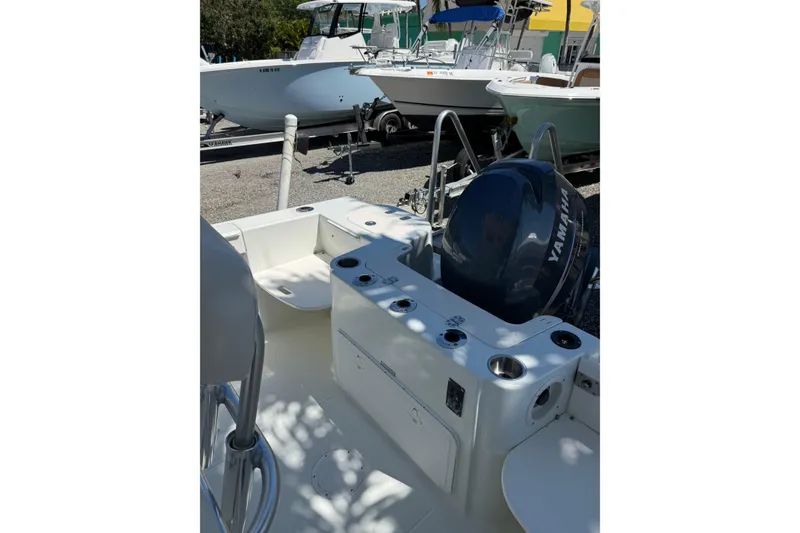 Slide: The Image of 2006 Sailfish 218 CC boat with Yamaha outboard motor, docked in a marina. - 2