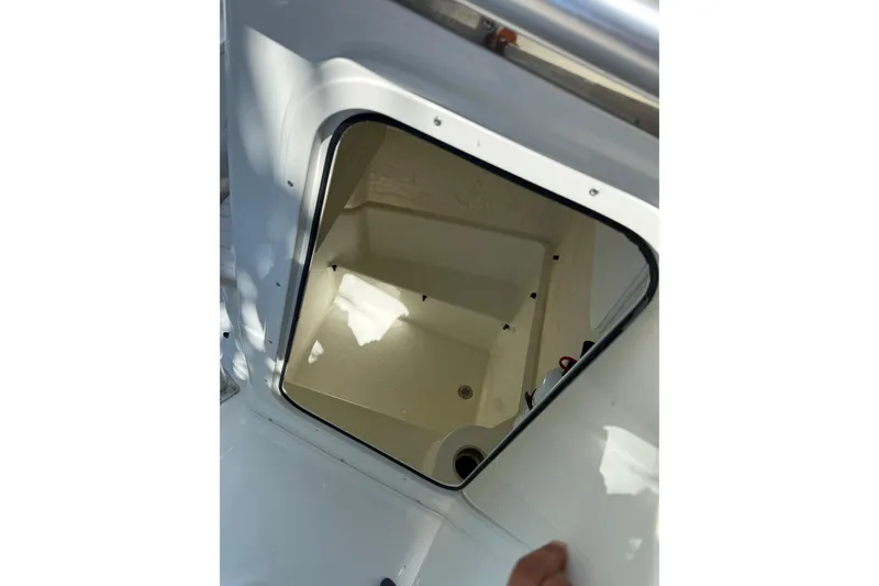 Slide: The Image of Open storage compartment on 2006 Sailfish 218 CC boat, showcasing interior space. - 8