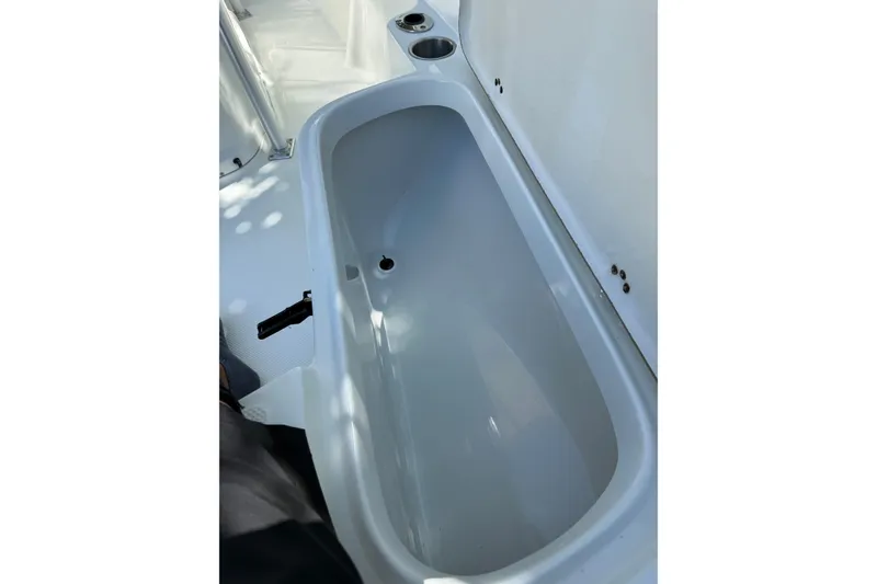 Slide: The Image of 2006 Sailfish 218 CC boat interior storage compartment with cup holders. - 9