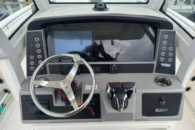 Slide: The Image of 2025 Robalo R250 Center Console dashboard with steering wheel and modern controls. - 5