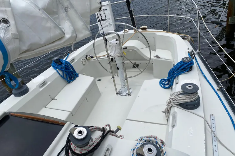 Slide: The Image of Cockpit of a 1981 C&C 40 sailboat with steering wheel and ropes. - 13