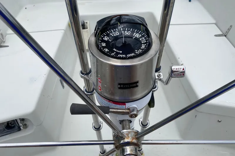 Slide: The Image of Compass and steering wheel on a 1981 C&C 40 sailboat cockpit. - 14