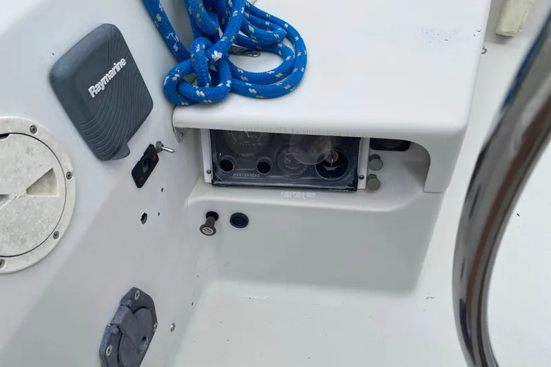 Slide: The Image of Cockpit controls of a 1981 C&C 40 sailboat with Raymarine equipment and blue rope. - 16