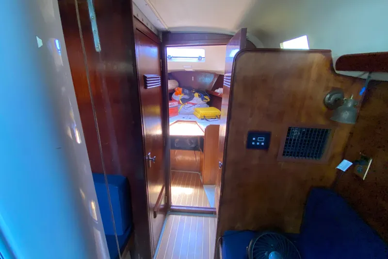 Slide: The Image of Interior of a 1981 C&C 40 sailboat, featuring wooden cabinetry and cozy cabin space. - 24