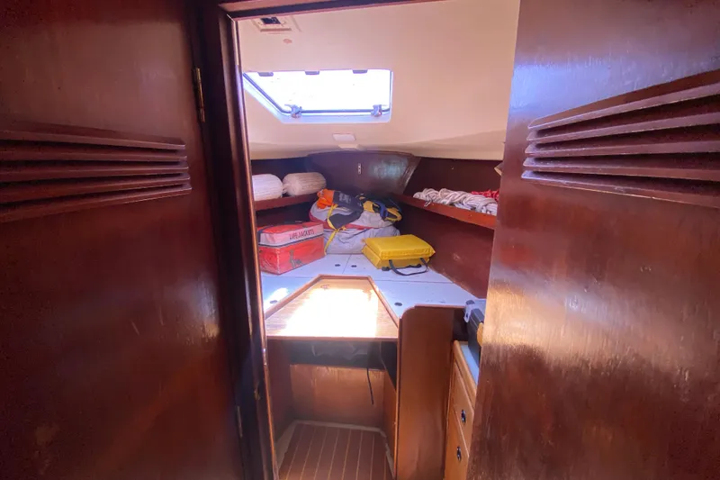 Slide: The Image of Interior cabin of a 1981 C&C 40 sailboat with life jackets and storage. - 25