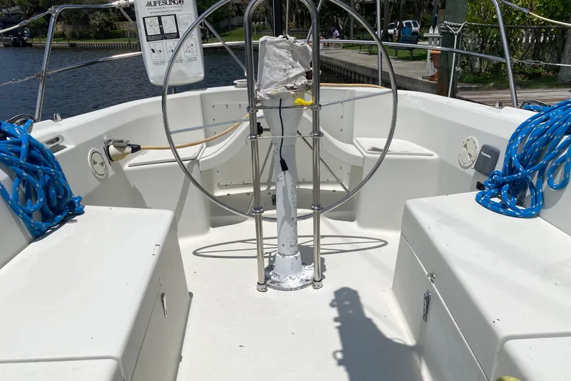 Slide: The Image of Cockpit of a 1981 C&C 40 sailboat with steering wheel and blue ropes. - 30