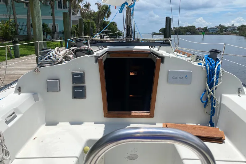 Slide: The Image of Cockpit of a 1981 C&C 40 sailboat with navigation equipment and ropes. - 32