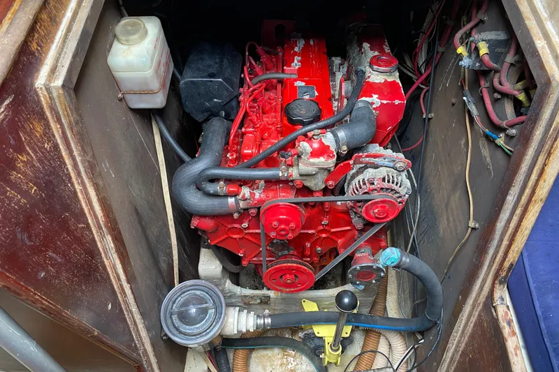 Slide: The Image of Engine compartment of a 1981 C&C 40 sailboat, featuring a red marine engine. - 34
