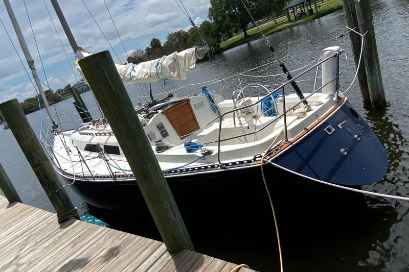 Slide: The Image of 1981 C&C 40 sailboat docked at a marina, featuring a sleek design and spacious deck. - 6