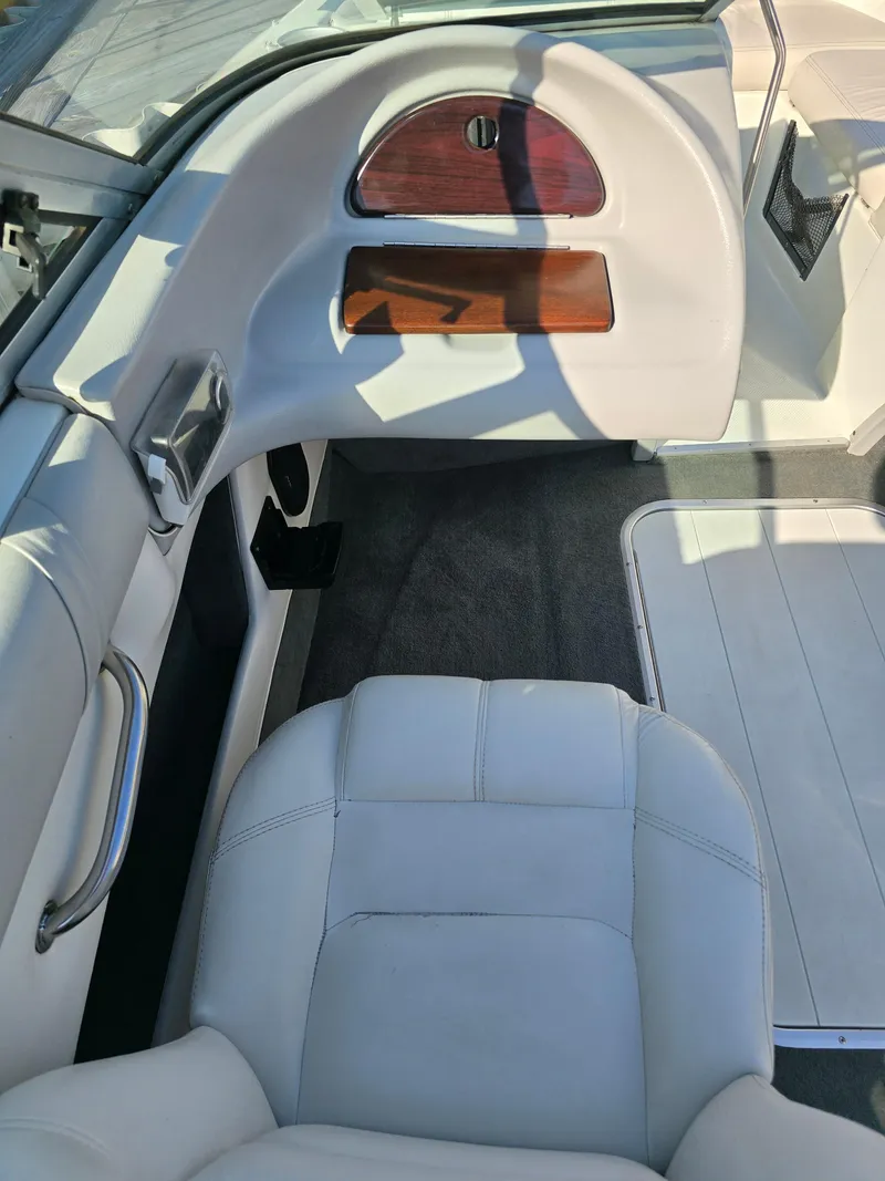 Slide: The Image of Interior of a 2000 Mariah 20 Shabah boat with white seating and wood accents. - 12