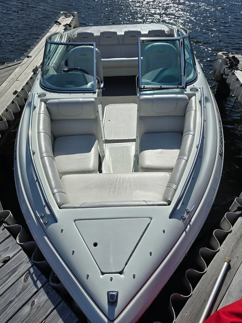 Slide: The Image of 2000 Mariah 20 Shabah boat docked on water, featuring sleek design and comfortable seating. - 14