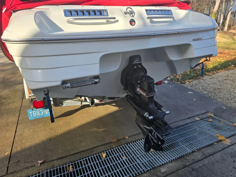 Slide: The Image of Rear view of a 2000 Mariah 20 Shabah boat on a trailer, with a red cover. - 15