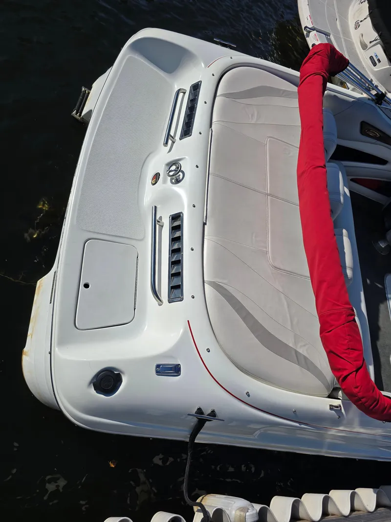 Slide: The Image of Rear view of a 2000 Mariah 20 Shabah boat with red cover on water. - 2