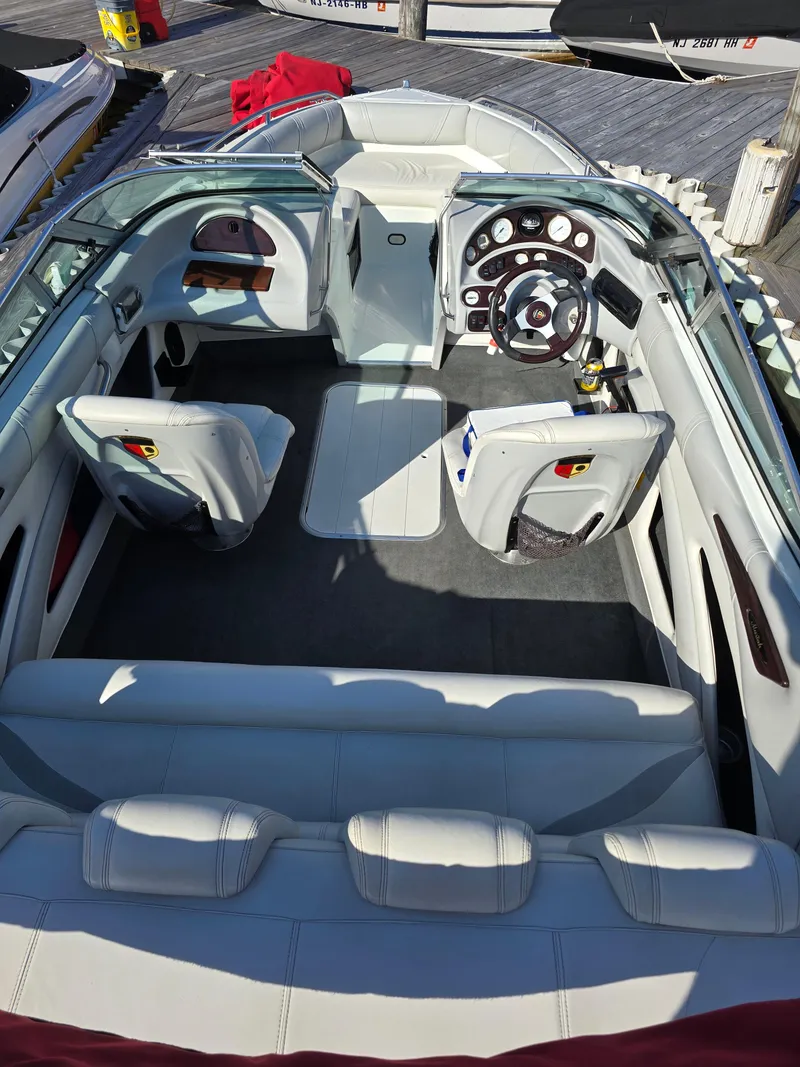 Slide: The Image of Interior of a 2000 Mariah 20 Shabah boat with white seating and modern dashboard. - 3