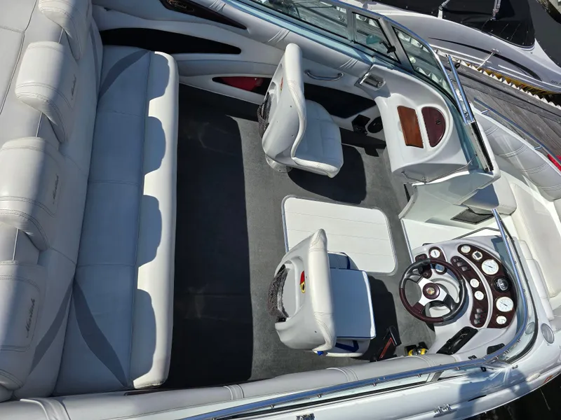 Slide: The Image of Interior of a 2000 Mariah 20 Shabah boat with white seating and dashboard. - 4
