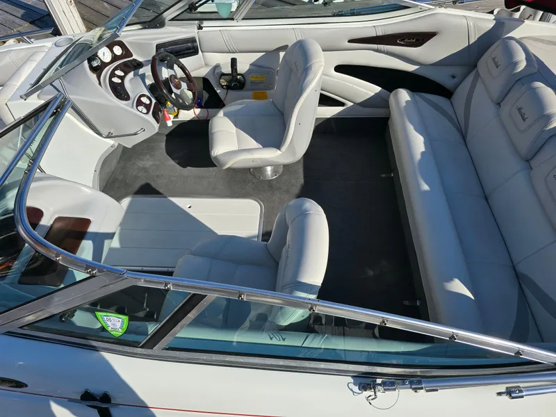 Slide: The Image of Interior of a 2000 Mariah 20 Shabah boat with white seating and steering console. - 6