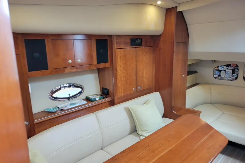 Slide: The Image of Luxurious interior of 2004 Cruisers Yachts 400 Express with wood cabinetry and plush seating. - 12
