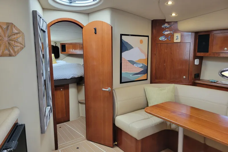Slide: The Image of 2004 Cruisers Yachts 400 Express interior with cozy seating and modern decor. - 2