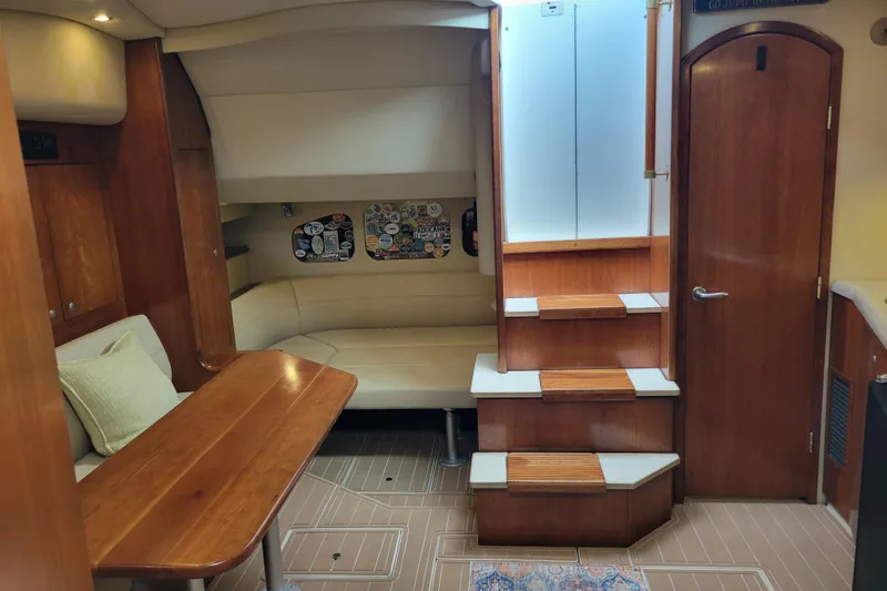 Slide: The Image of Interior of 2004 Cruisers Yachts 400 Express, featuring wood finishes and cozy seating area. - 22