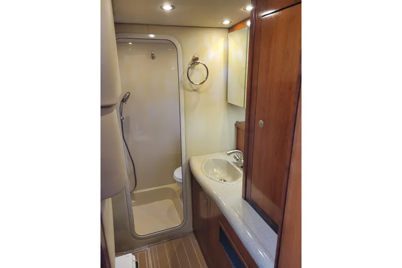 Slide: The Image of Luxurious bathroom in 2004 Cruisers Yachts 400 Express, featuring shower and elegant wood cabinetry. - 26