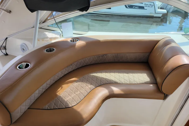 Slide: The Image of Luxurious seating on a 2004 Cruisers Yachts 400 Express, featuring brown leather upholstery. - 33