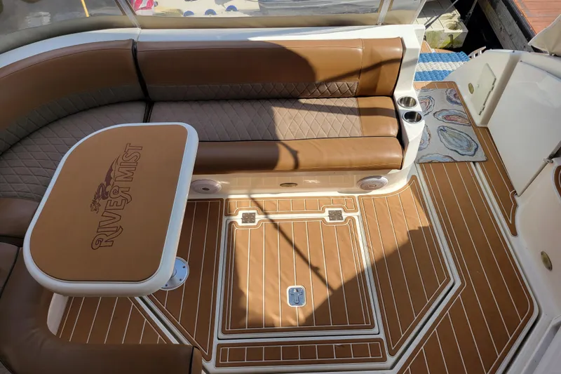 Slide: The Image of Luxurious 2004 Cruisers Yachts 400 Express interior with brown seating and custom table. - 35