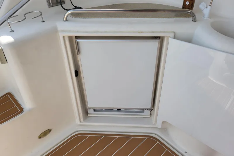 Slide: The Image of 2004 Cruisers Yachts 400 Express interior with built-in fridge and sink. - 37