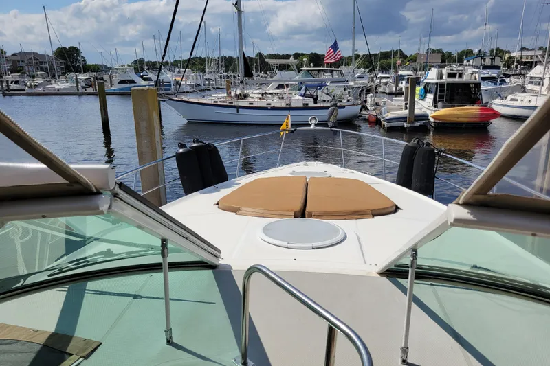 Slide: The Image of 2004 Cruisers Yachts 400 Express docked in a marina with other boats. - 38
