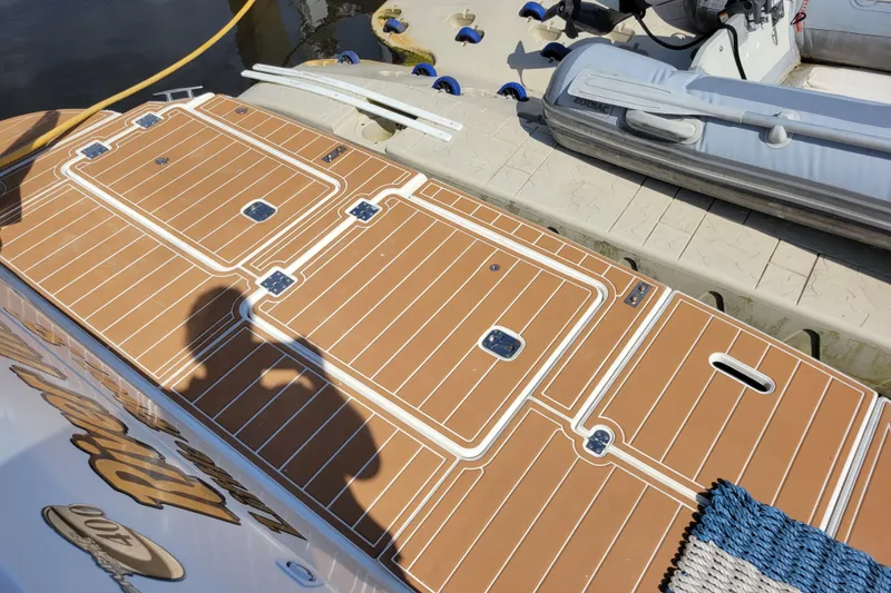 Slide: The Image of 2004 Cruisers Yachts 400 Express swim platform with custom decking and docked inflatable boat. - 41
