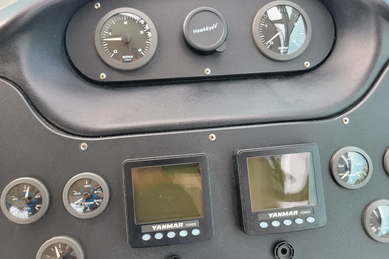 Slide: The Image of Dashboard of a 2004 Cruisers Yachts 400 Express with gauges and Yanmar displays. - 44