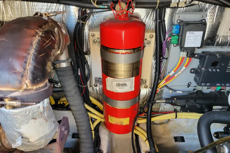 Slide: The Image of Engine room of 2004 Cruisers Yachts 400 Express with fire extinguisher and wiring. - 51