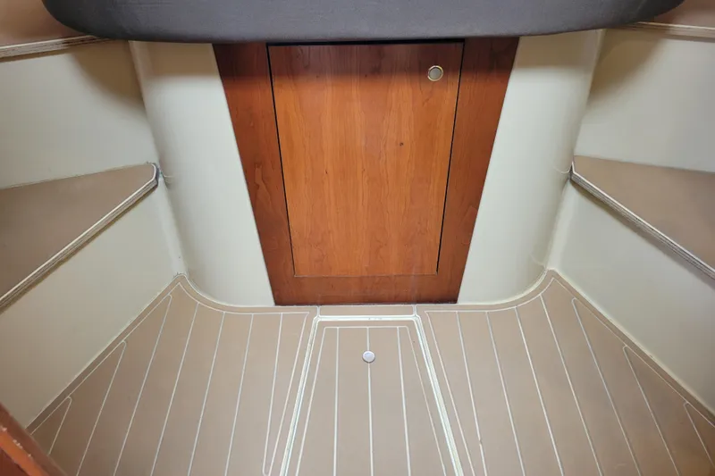 Slide: The Image of 2004 Cruisers Yachts 400 Express cabin interior with wooden door and beige flooring. - 6