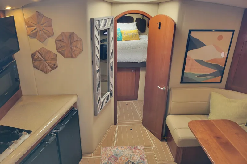 Slide: The Image of Interior of 2004 Cruisers Yachts 400 Express with modern decor and cozy seating area. - 7