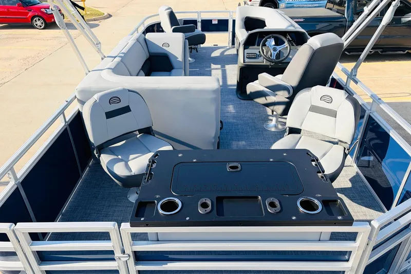 Slide: The Image of 2026 Sun Tracker SportFish 20 DLX pontoon boat interior with seating and steering console. - 10