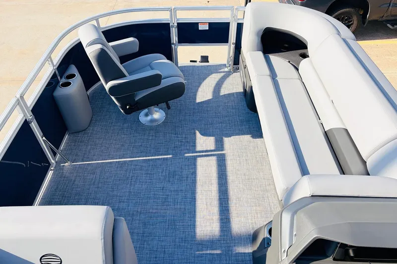 Slide: The Image of 2026 Sun Tracker SportFish 20 DLX pontoon boat interior with seating and cup holders. - 11