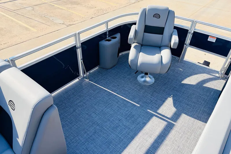 Slide: The Image of 2026 Sun Tracker SportFish 20 DLX pontoon boat interior with gray seating and carpet. - 13