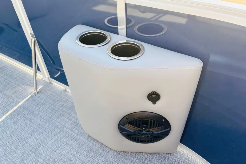 Slide: The Image of Cup holders and speaker on 2026 Sun Tracker SportFish 20 DLX boat interior. - 15