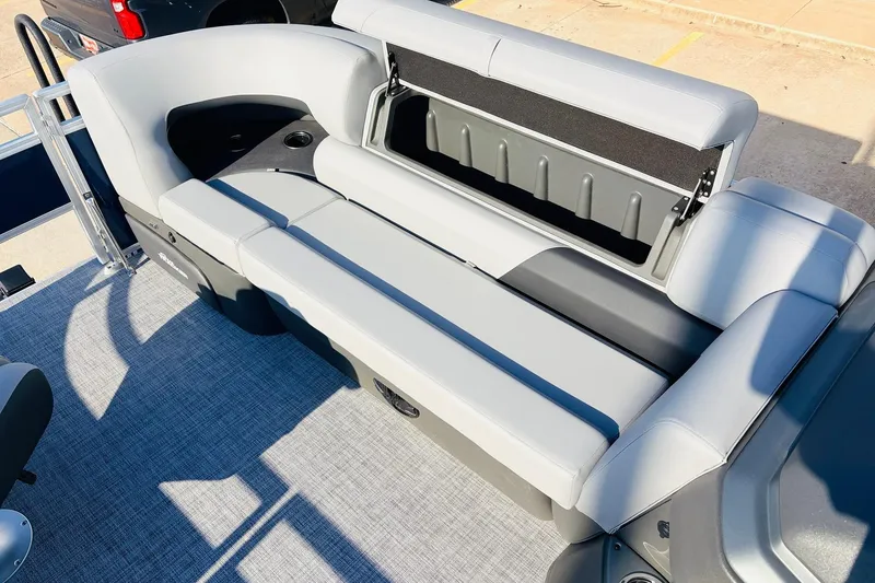 Slide: The Image of 2026 Sun Tracker SportFish 20 DLX boat interior with gray seating and storage compartment. - 17
