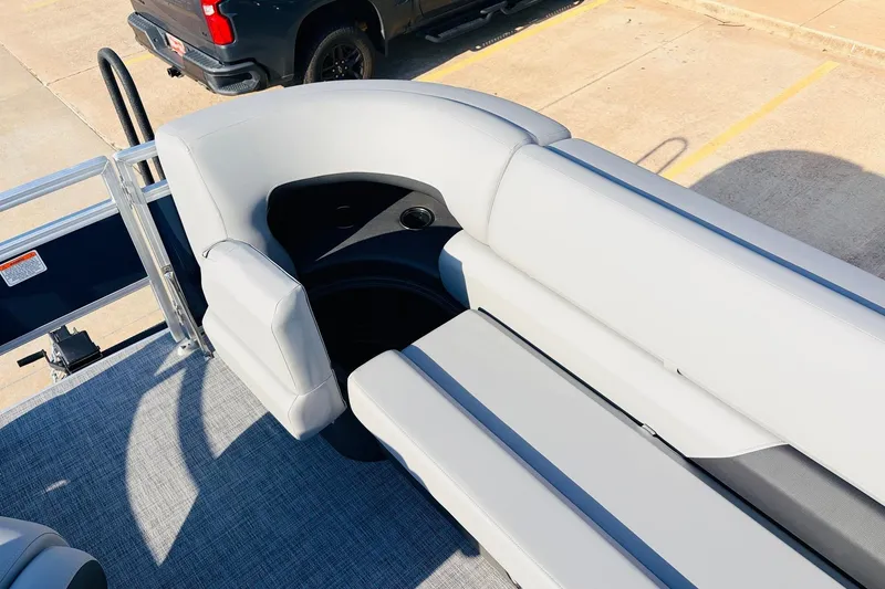 Slide: The Image of 2026 Sun Tracker SportFish 20 DLX boat interior with gray seating and cup holder. - 19