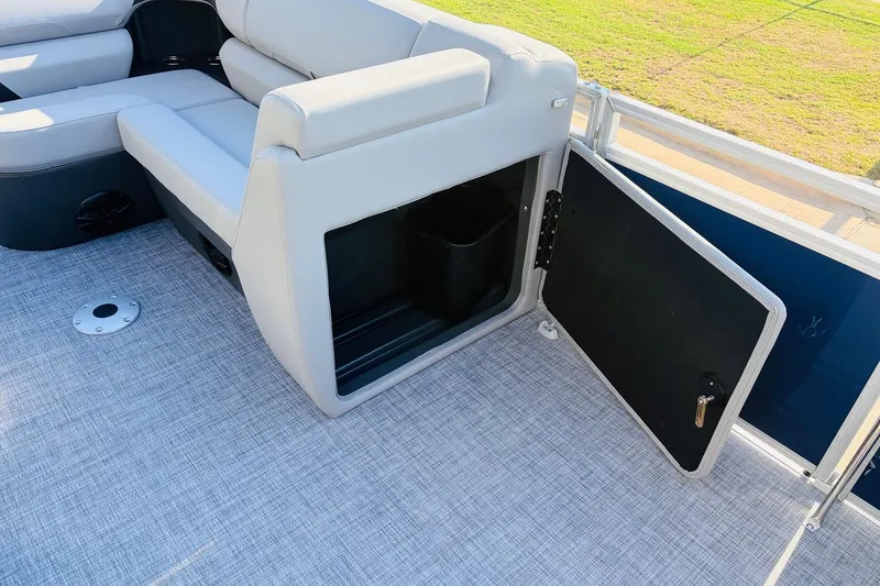 Slide: The Image of 2026 Sun Tracker SportFish 20 DLX boat interior with open storage compartment and seating. - 24
