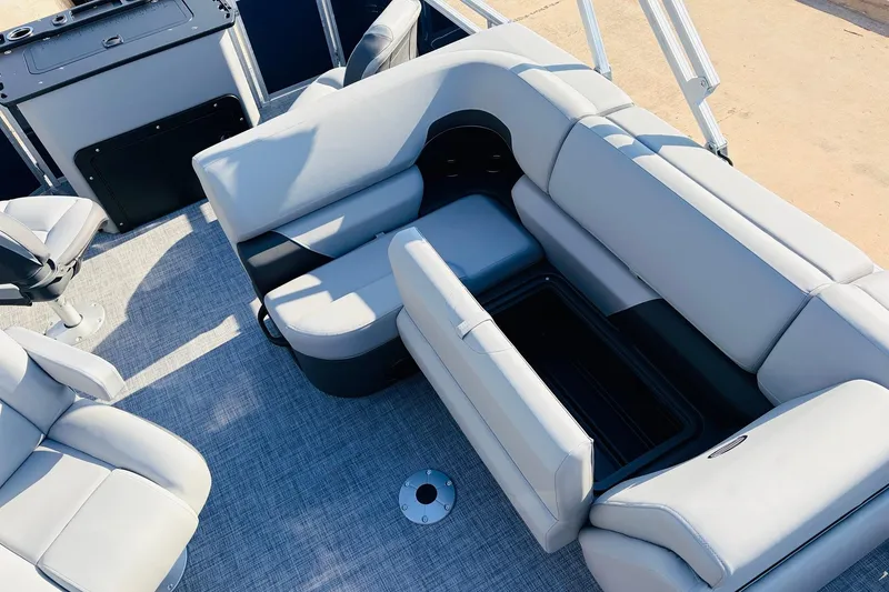 Slide: The Image of 2026 Sun Tracker SportFish 20 DLX boat interior with gray seating and storage compartments. - 26