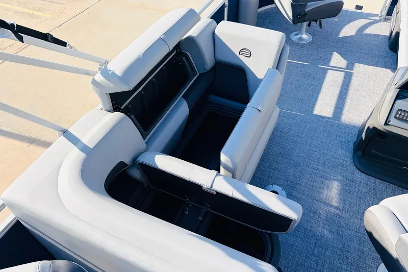 Slide: The Image of 2026 Sun Tracker SportFish 20 DLX interior with open storage compartments and seating. - 29