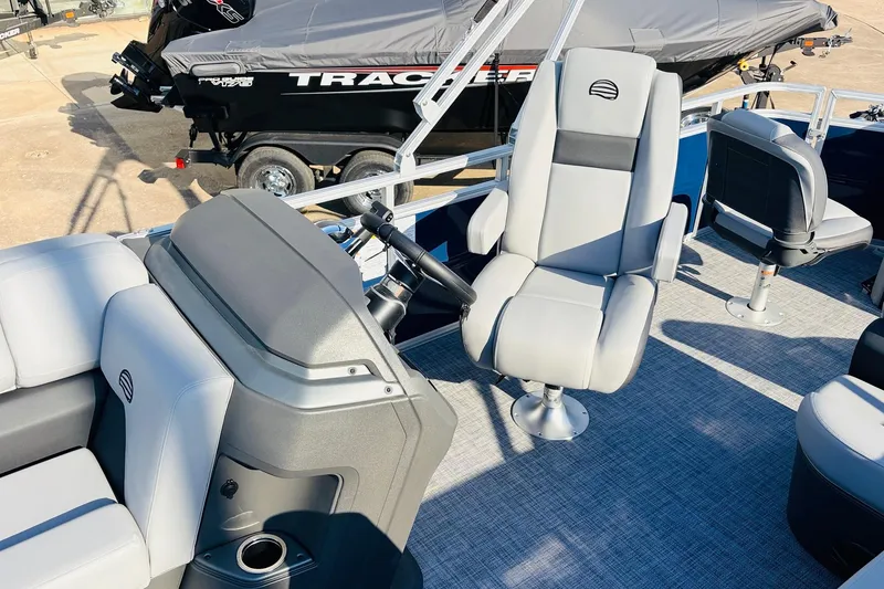 Slide: The Image of 2026 Sun Tracker SportFish 20 DLX boat interior with modern seating and steering console. - 30