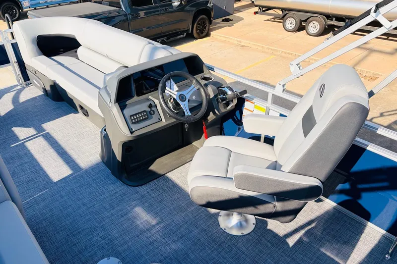 Slide: The Image of 2026 Sun Tracker SportFish 20 DLX pontoon boat interior with steering console and seating. - 31