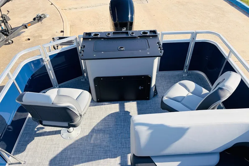 Slide: The Image of 2026 Sun Tracker SportFish 20 DLX pontoon boat interior with seating and control panel. - 37