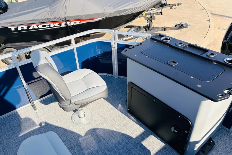 Slide: The Image of 2026 Sun Tracker SportFish 20 DLX interior with seating and storage unit. - 40
